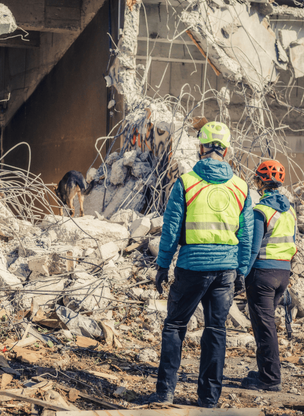 Two workers examining earthquake damage