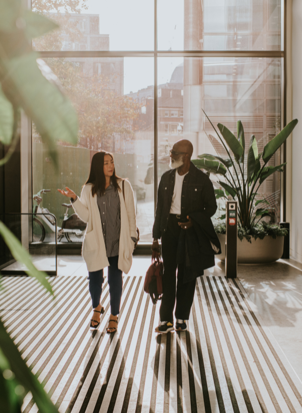 Two business people walking through modern office