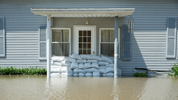 Home in flood with sandbags at door